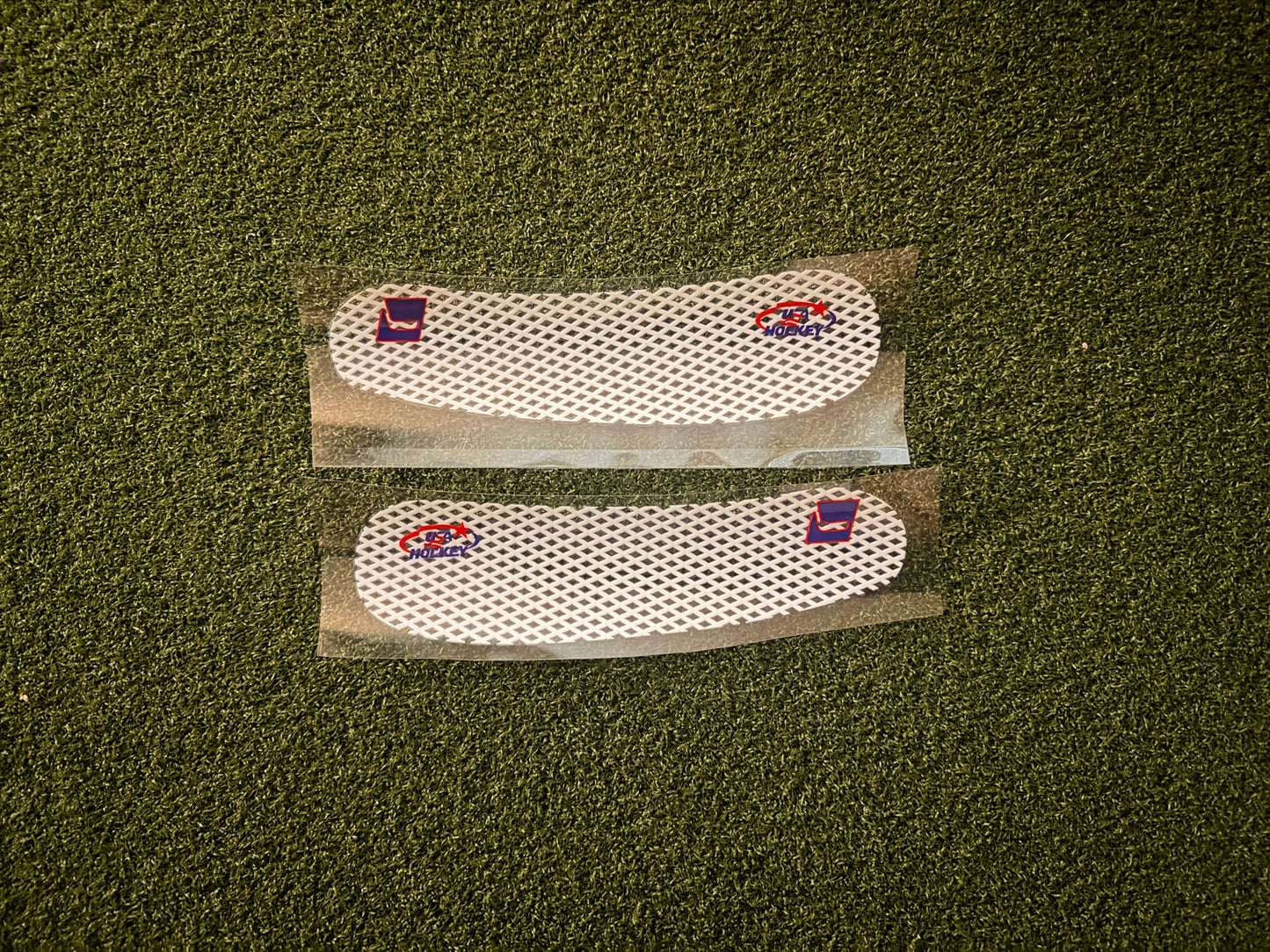 Two custom, white blade tape stickers with HKY IQ and USA Hockey logos