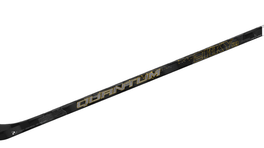 A black Quantum hockey stick with gold and white details on the shaft and branding.
